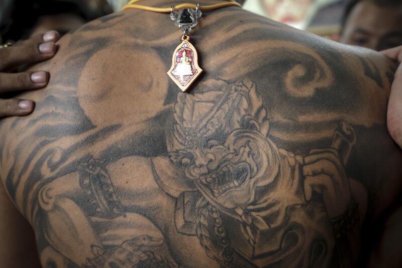 A devotee gets a San Yant tattoo by a tattoo master during the annual Magic Tattoo Festival at Wat Bang Phra in Nakhon Pathom province, Thailand, 23 March 2024. The Magic Tattoo Festival, also known as the 'Wai Khru Ceremony' (Wai Khru means 'honour the teacher'), attracts devotees from across the country who travel to Wat Bang Phra monastery to receive their traditional tattoos and pay their respects to the temple's master tattooist during the Magic Tattoo Festival. During the festival, devotees sit facing the main shrine before many, 'possessed' by the spirit of the animal tattooed on their skin, stand up, mimic the animal's behaviour and eventually make their way towards the main shrine, sometimes running at high speed, until they are stopped by a group of helpers and medics who bring them out of the trance by rubbing their ears. Receiving a Sak Yant is highly respected in Thailand, and many believe the tattoos have mystical powers to ward off bad luck and protect people from harm. Matrix Images / Diego Azubel