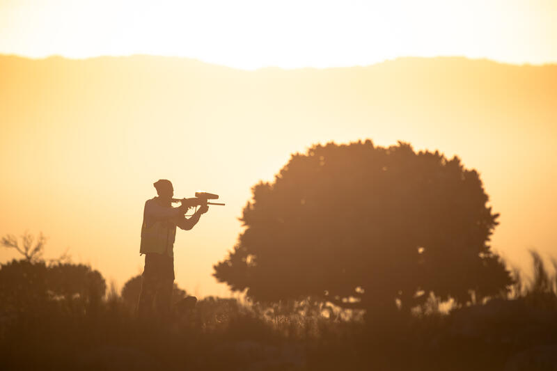 A City of Cape Town approved baboon monitor fires a paintball marker toward baboons of the Klein Slangkop baboon troop on the Slangkop Mountain above the coastal suburb of Kommetjie, Cape Town, South Africa on May 7,2020. In Cape Town, South Africa, the coexistence of humans and Chacma baboons in urban areas, particularly in villages like Kommetjie, has led to increasing tensions and conflicts. Despite efforts under the City of Cape Town's 'Baboon Strategic Management Plan,' which involves tracking, educating residents, and reducing baboon harm, hostilities between baboons and humans, including attacks on pets and property damage, continue to rise. The presence of baboons, who forage and sleep within urban spaces, has divided the community, pitting animal rights activists against frustrated residents. A recent survey of Kommetjie residents revealed that 55 percent have daily encounters with baboons, 85 percent have had baboons enter their homes, and 83 percent have altered their lifestyles to avoid conflict. However, with no alternative plans in place, the struggle between maintaining baboon welfare and ensuring human safety remains unresolved. Matrix Images / Alan van Gysen