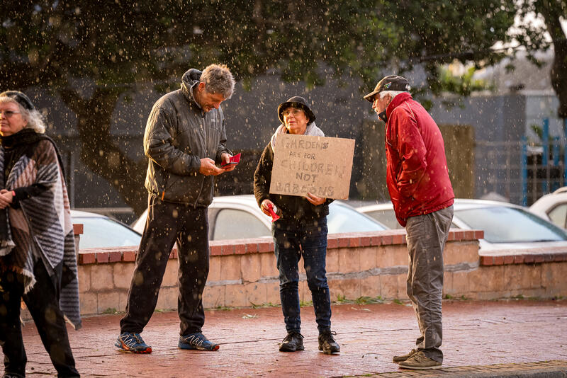 Kommetjie residents protest against the inaction of authorities with regard to habituated baboons who occupy the urban space in Kommetjie, Cape Town, South Africa on August 4,2024.  In Cape Town, South Africa, the coexistence of humans and Chacma baboons in urban areas, particularly in villages like Kommetjie, has led to increasing tensions and conflicts. Despite efforts under the City of Cape Town's 'Baboon Strategic Management Plan,' which involves tracking, educating residents, and reducing baboon harm, hostilities between baboons and humans, including attacks on pets and property damage, continue to rise. The presence of baboons, who forage and sleep within urban spaces, has divided the community, pitting animal rights activists against frustrated residents. A recent survey of Kommetjie residents revealed that 55 percent have daily encounters with baboons, 85 percent have had baboons enter their homes, and 83 percent have altered their lifestyles to avoid conflict. However, with no alternative plans in place, the struggle between maintaining baboon welfare and ensuring human safety remains unresolved. Matrix Images / Alan van Gysen