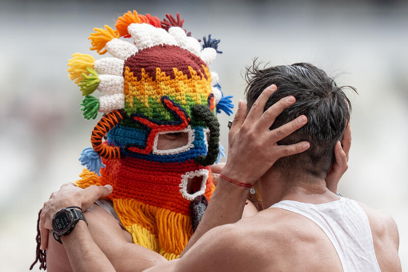 David Hurtado of Ecuador (L) wearing a traditional mask reacts with Jordy Rafael Jimenez Arroyo of Ecuador (R) after the mens 20km race walk final during the World Athletics Championships in Tokyo, Japan on September 20, 2025. Matrix Images / Nic Bothma