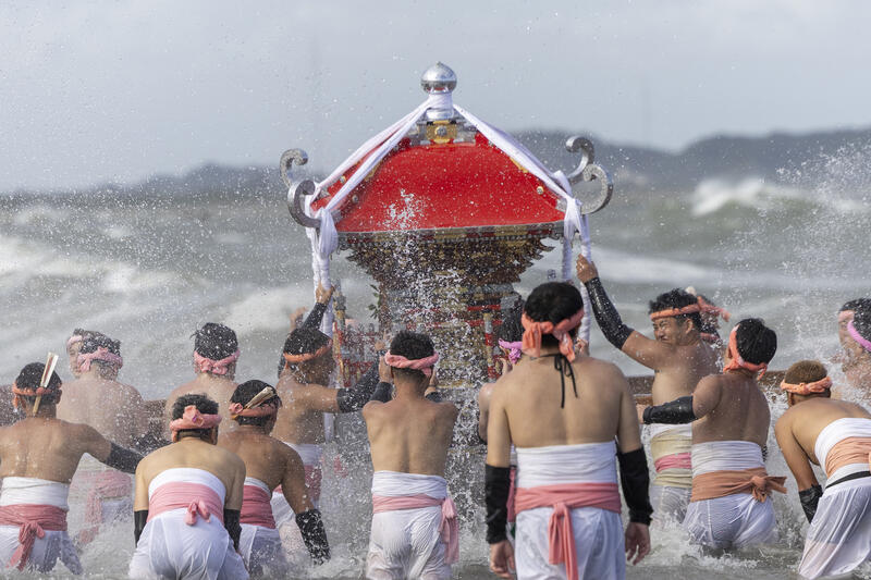 Participants take part in the Ohara Hadaka Matsuri festival in Ohara, Chiba, Japan on September 23, 2025. The festival held on 23–24 September 2025 in the coastal town of Ohara, Chiba, is a centuries-old Shinto festival with origins in the Edo period. Traditionally, the event is a communal prayer for a bountiful harvest and a successful fishing season, reflecting the deep connection between coastal communities and the natural world. Participants, wearing only the traditional fundoshi loincloths, carry heavy mikoshi (portable shrines) through the streets in a lively procession, accompanied by chants, drums, and the energy of the crowd. The festival’s most dramatic moment is the Shiofumi ritual, in which the shrine-bearers wade into the Pacific Ocean, braving the waves as an act of devotion and purification, symbolically linking human effort to the forces of nature. The festival concludes with a lantern-lit parade through the streets and a farewell ceremony, creating a striking visual spectacle at sunset. As part of Japan’s broader tradition of hadaka matsuri or Naked Festivals, the Ohara Matsuri emphasizes endurance, faith, and community solidarity, while preserving regional identity and continuity from the Edo period to the present. Celebrated at the start of autumn, the timing also aligns with Japan’s seasonal cycles, marking the transition from the harvest season to the cooler months and highlighting a cultural rhythm that honors nature’s cycles, human labor, and the enduring spiritual connection between people and the sea. Matrix Images / Simon Bonny