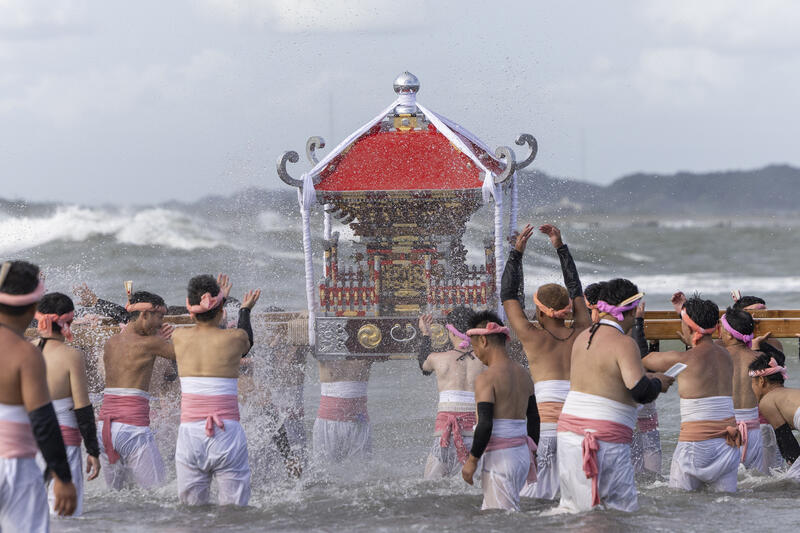 Participants take part in the Ohara Hadaka Matsuri festival in Ohara, Chiba, Japan on September 23, 2025. The festival held on 23–24 September 2025 in the coastal town of Ohara, Chiba, is a centuries-old Shinto festival with origins in the Edo period. Traditionally, the event is a communal prayer for a bountiful harvest and a successful fishing season, reflecting the deep connection between coastal communities and the natural world. Participants, wearing only the traditional fundoshi loincloths, carry heavy mikoshi (portable shrines) through the streets in a lively procession, accompanied by chants, drums, and the energy of the crowd. The festival’s most dramatic moment is the Shiofumi ritual, in which the shrine-bearers wade into the Pacific Ocean, braving the waves as an act of devotion and purification, symbolically linking human effort to the forces of nature. The festival concludes with a lantern-lit parade through the streets and a farewell ceremony, creating a striking visual spectacle at sunset. As part of Japan’s broader tradition of hadaka matsuri or Naked Festivals, the Ohara Matsuri emphasizes endurance, faith, and community solidarity, while preserving regional identity and continuity from the Edo period to the present. Celebrated at the start of autumn, the timing also aligns with Japan’s seasonal cycles, marking the transition from the harvest season to the cooler months and highlighting a cultural rhythm that honors nature’s cycles, human labor, and the enduring spiritual connection between people and the sea. Matrix Images / Simon Bonny
