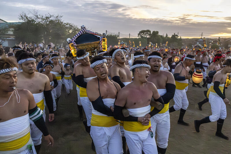 Participants take part in the Ohara Hadaka Matsuri festival in Ohara, Chiba, Japan on September 23, 2025. The festival held on 23–24 September 2025 in the coastal town of Ohara, Chiba, is a centuries-old Shinto festival with origins in the Edo period. Traditionally, the event is a communal prayer for a bountiful harvest and a successful fishing season, reflecting the deep connection between coastal communities and the natural world. Participants, wearing only the traditional fundoshi loincloths, carry heavy mikoshi (portable shrines) through the streets in a lively procession, accompanied by chants, drums, and the energy of the crowd. The festival’s most dramatic moment is the Shiofumi ritual, in which the shrine-bearers wade into the Pacific Ocean, braving the waves as an act of devotion and purification, symbolically linking human effort to the forces of nature. The festival concludes with a lantern-lit parade through the streets and a farewell ceremony, creating a striking visual spectacle at sunset. As part of Japan’s broader tradition of hadaka matsuri or Naked Festivals, the Ohara Matsuri emphasizes endurance, faith, and community solidarity, while preserving regional identity and continuity from the Edo period to the present. Celebrated at the start of autumn, the timing also aligns with Japan’s seasonal cycles, marking the transition from the harvest season to the cooler months and highlighting a cultural rhythm that honors nature’s cycles, human labor, and the enduring spiritual connection between people and the sea. Matrix Images / Simon Bonny