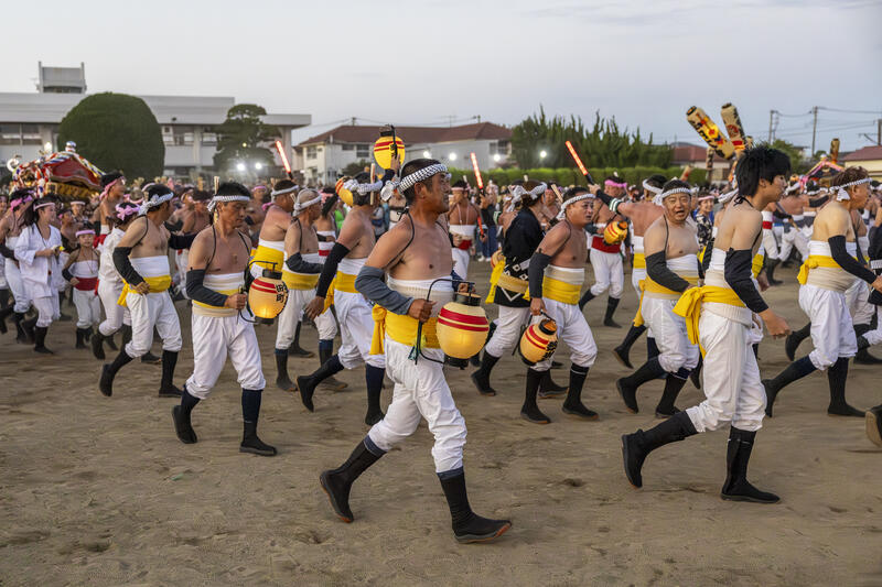 Participants take part in the Ohara Hadaka Matsuri festival in Ohara, Chiba, Japan on September 23, 2025. The festival held on 23–24 September 2025 in the coastal town of Ohara, Chiba, is a centuries-old Shinto festival with origins in the Edo period. Traditionally, the event is a communal prayer for a bountiful harvest and a successful fishing season, reflecting the deep connection between coastal communities and the natural world. Participants, wearing only the traditional fundoshi loincloths, carry heavy mikoshi (portable shrines) through the streets in a lively procession, accompanied by chants, drums, and the energy of the crowd. The festival’s most dramatic moment is the Shiofumi ritual, in which the shrine-bearers wade into the Pacific Ocean, braving the waves as an act of devotion and purification, symbolically linking human effort to the forces of nature. The festival concludes with a lantern-lit parade through the streets and a farewell ceremony, creating a striking visual spectacle at sunset. As part of Japan’s broader tradition of hadaka matsuri or Naked Festivals, the Ohara Matsuri emphasizes endurance, faith, and community solidarity, while preserving regional identity and continuity from the Edo period to the present. Celebrated at the start of autumn, the timing also aligns with Japan’s seasonal cycles, marking the transition from the harvest season to the cooler months and highlighting a cultural rhythm that honors nature’s cycles, human labor, and the enduring spiritual connection between people and the sea. Matrix Images / Simon Bonny