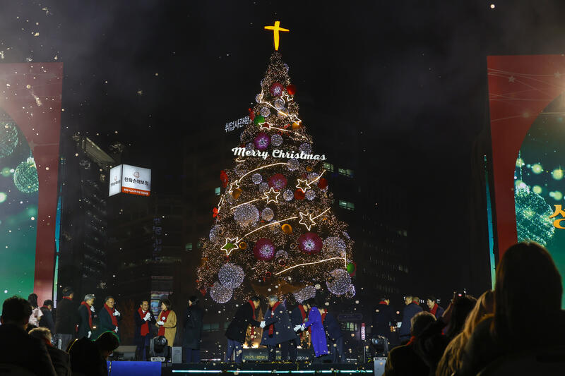 A large Christmas tree is illuminated at Seoul Plaza