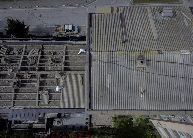 Workers Remove Asbestos Tiles from Housing Roof in Kosovo