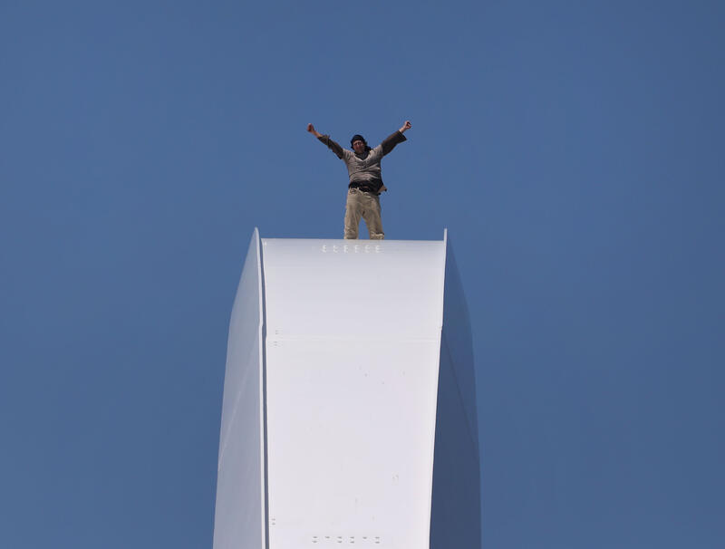 Activist Protesting Iran War Atop Frederick Douglass Bridge, in Washington DC, USA.