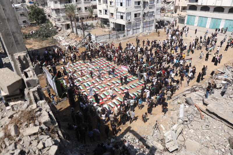 Palestinians attend a funeral for 112 members of the Hassayna and Abu Sharia clan in Gaza City